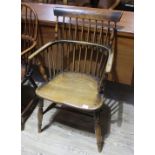 A 19th century elm comb back Windsor armchair, height 89cm, width 55.5cm and depth 52cm. Evidence of