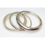A Modernist textured silver bangle by Poppy Dandiya and two others similar, diameter approx. 6.5cm