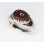 A contemporary silver ring set with an oval amethyst cabochon, sponsor's mark 'GL', London 1998,