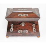 A 19th century mother of pearl inlaid rosewood tea caddy of sarcophagus form, length 23.5cm.