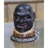 A reproduction cast metal money bank The Salted Peanut Man.