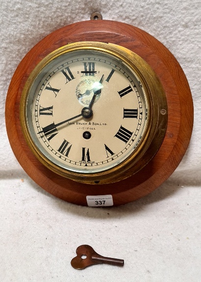 A ship's bulkhead clock 'John Bruce & Co, Liverpool', mounted on teak.