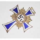 A German WWII Cross of Honour medal.