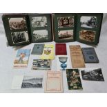 Two postcard albums and various items of ephemera including pocket books and loose postcards.