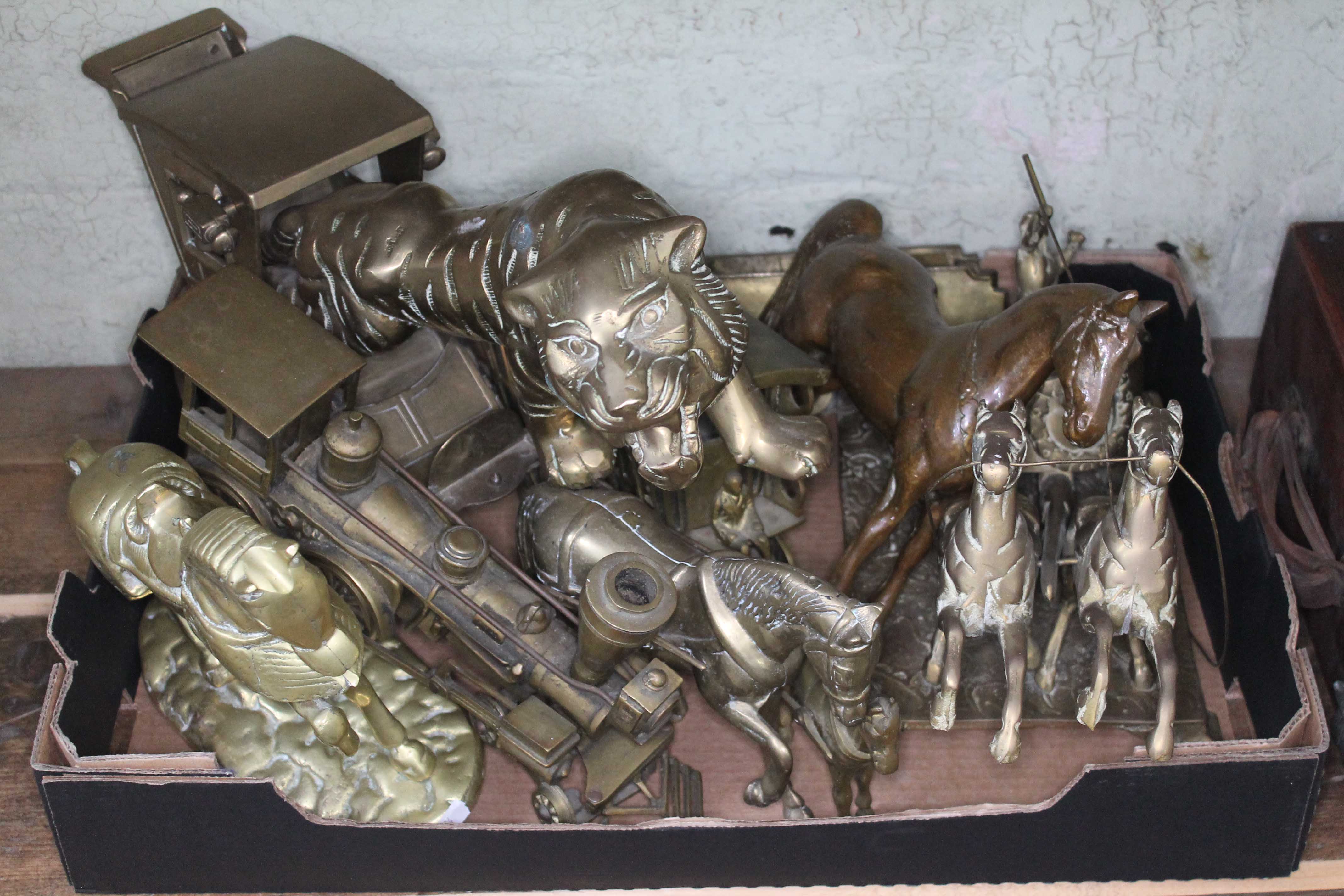 A box of assorted brassware including horses, carriages, a train etc.