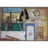 A box of assorted items including spectacles, pens, hallmarked silver teaspoons, a post card, stamps