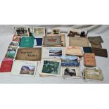 A box of ephemera including old photographs, postcards and guide books, mostly UK travel related.