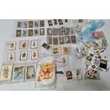 A collection of various cigarette cards and cigarette card silks including butterfly silks etc.