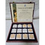 A wooden presentation box containing 'THE MOST FAMOUS COIN REPLICAS', 12 coins, with certificate.