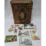 A gilt metal mounted family bible, assorted post cards, cigarette cards.