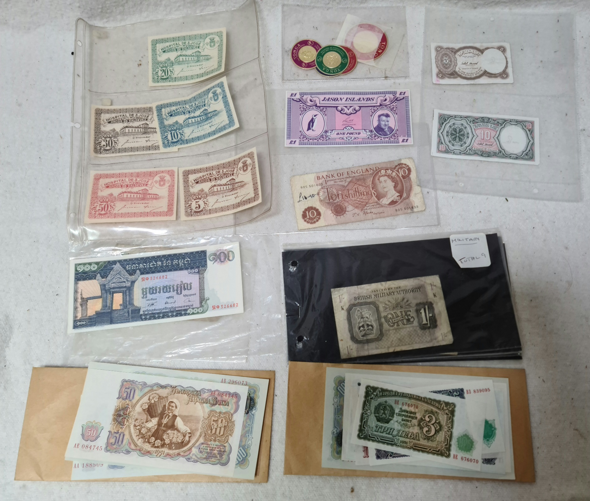 A box containing various UK, world and military banknotes.