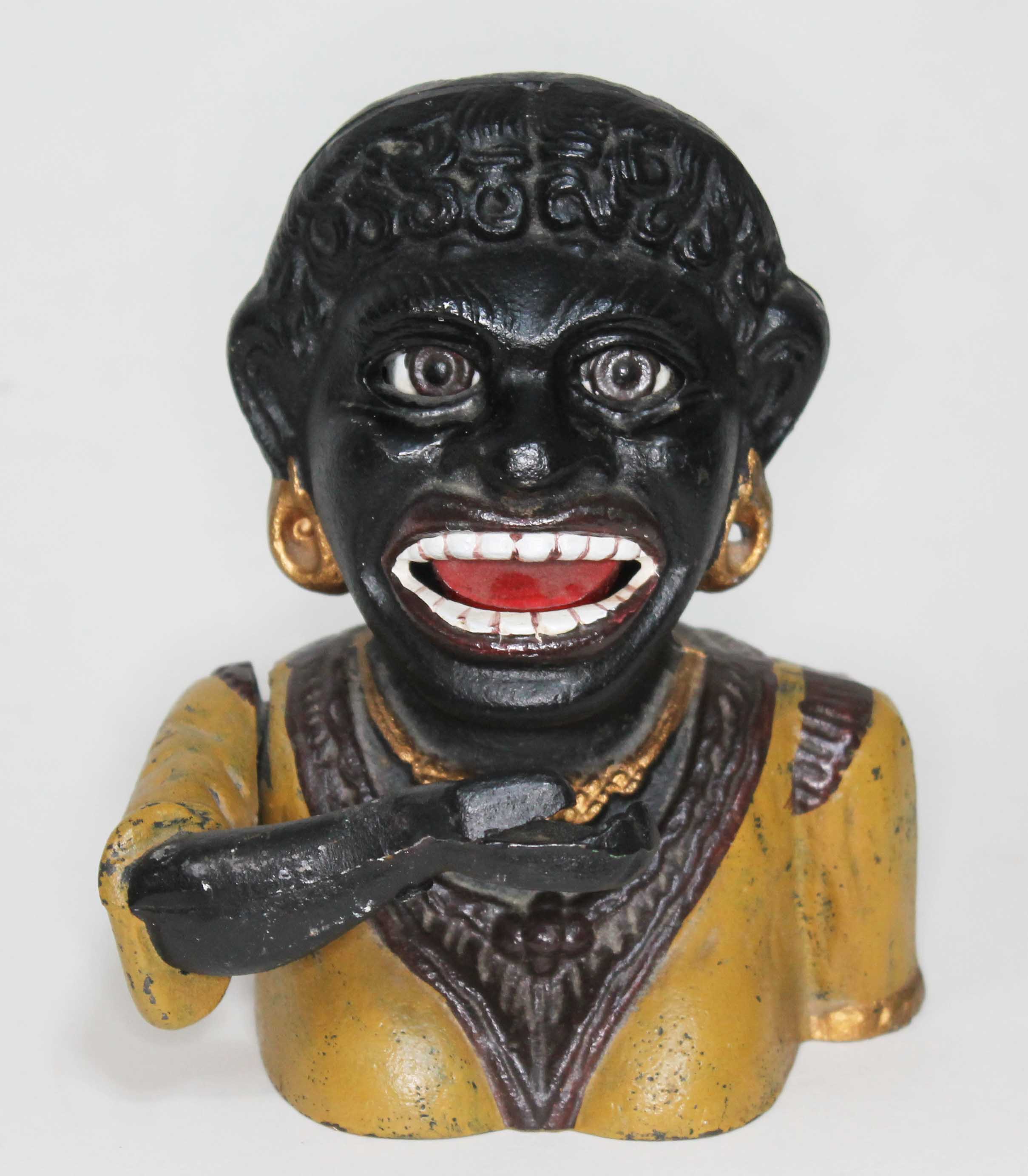 A reproduction cast metal money bank Dinah.