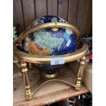 A semi-precious terrestrial globe on brass stand.