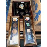 A set of three framed coin/stamp displays.