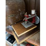 A vintage Grain miniature toy sewing machine in case.