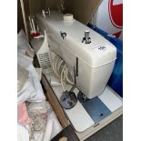 A New Home electric sewing machine with pedal.