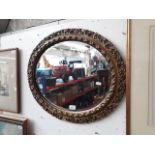 An oval gilt framed mirror, 62cm x 52cm.