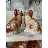 A pair of ceramic spaniels, by L. Bentley.