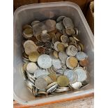 A tub containing a collection of world coins.