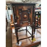 A 1920s oak bedside cabinet on bobbin turned supports.