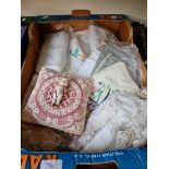 A box of assorted linen and porcelain doll.