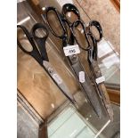 Three pairs of dressmakers scissors including pinking shears.