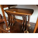 An Ercol dark elm nest of tables.