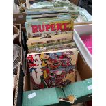 A box of Rupert and Giles annuals.