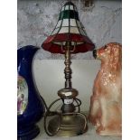 A brass and leaded glass table lamp.