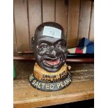 A reproduction cast metal money bank The Salted Peanut Man.