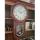 An American drop dial wall clock, with key and pendulum.