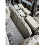 A concrete garden bench plank on plinths.