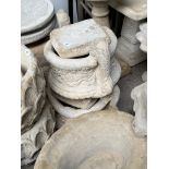 A pair of garden urns on pedestals.