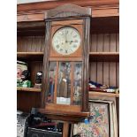 An oak cased wall clock.