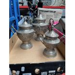 3 graduated Middle Eastern metal urns.