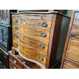 A George III serpentine front mahogany chest of drawers with brushing slide, the canted corners