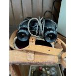 A pair of vintage binoculars in leather case.