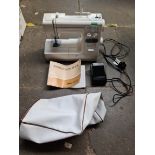 An electric Janome sewing machine with pedal and instructions manual, model number MS 2522