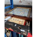 A box of ephemera and a framed collection of cigarette cards.