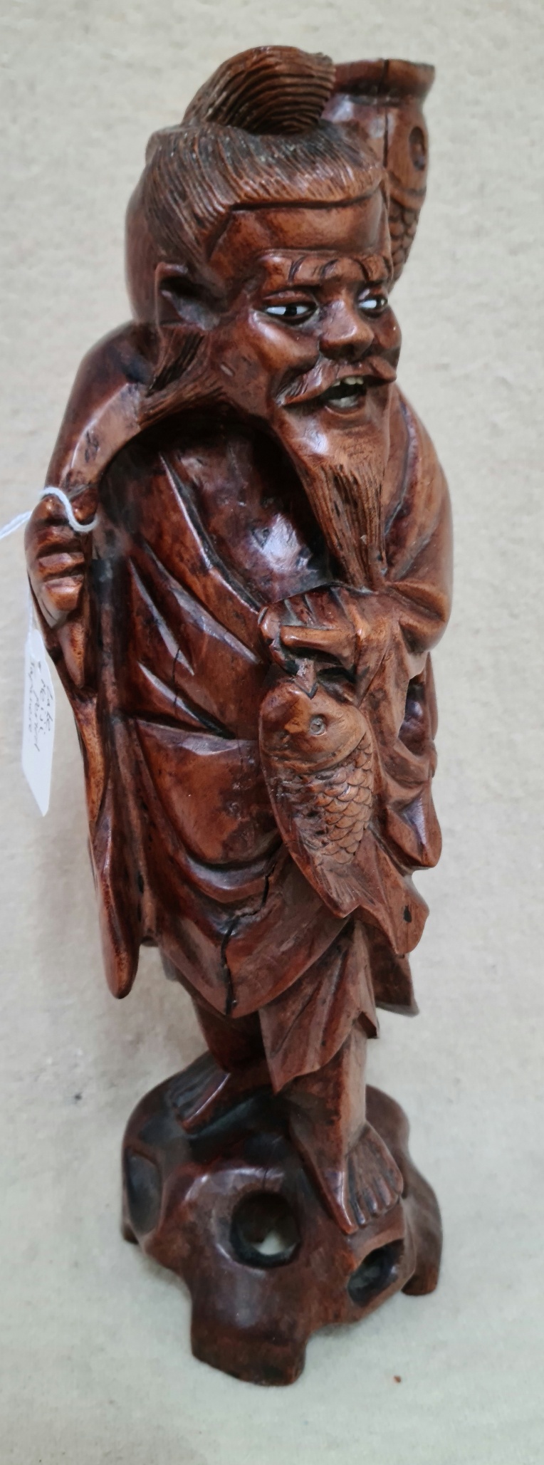A Japanese late Meiji period wood carving of a fisherman, height 35.5cm.