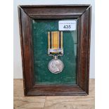 A Queens South Africa replica medal, framed.