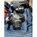 A camera bag containing a Pentax ME Super camera with SMC Pentax-M 1:1.7 50mm lens, a Hoya 62mm