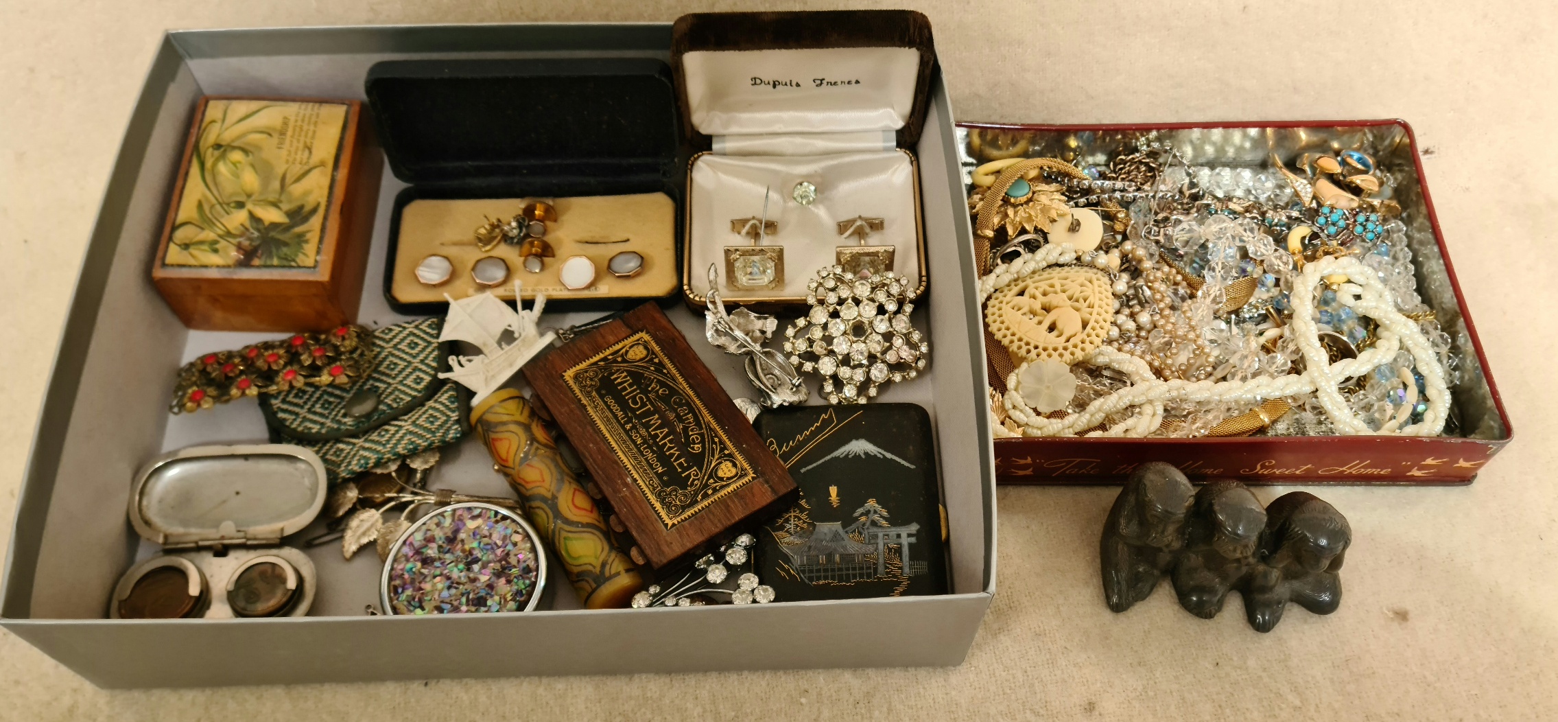 A collection of jewellery and collectables to include celluloid, pearls, brooches, cuff-links,