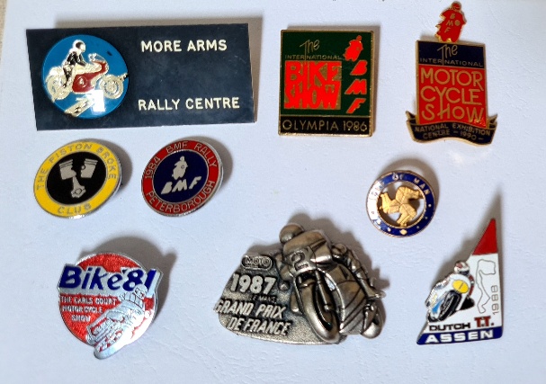 A group of 9 motorcycle pin badges