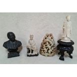 A carved ivory figure on carved wood stand, 2 soapstone Oriental group figures and a cast metal