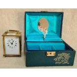 A reproduction carriage clock in brass and glass and a vintage musical jewellery box - ballerina.