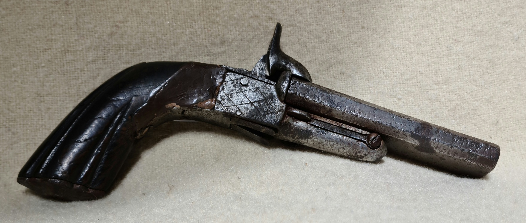 An antique double barrelled pistol with drop down triggers.