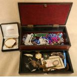 A wooden jewellery box containing various costume jewellery and mixed collectables to include silver