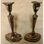 A hallmarked silver candlestick and an EPNS candlestick, height for both 23cm.