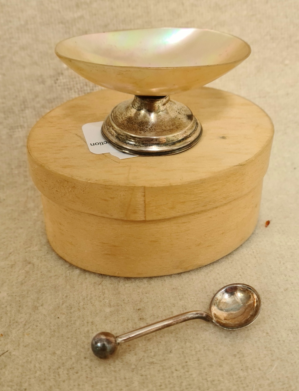 A hallmarked silver and MOP salt with small spoon.